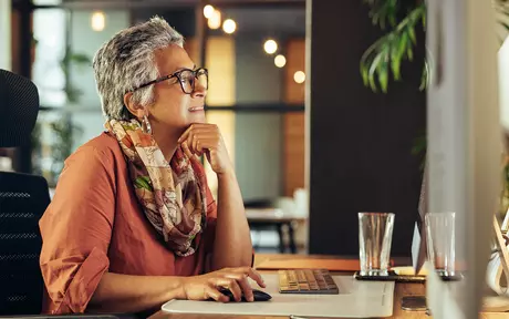 old woman sit in a desk