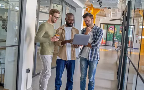 3 men with a laptop