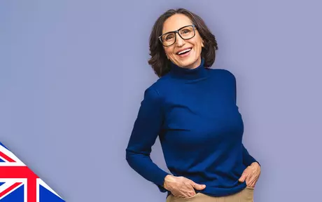 Smiling woman with glasses on purple background